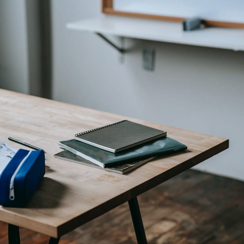 Student desk with copybooks and pencil case